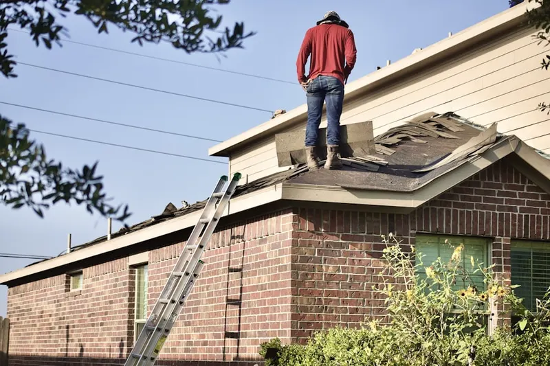 Professional roofer working on a residential roof in Continental North